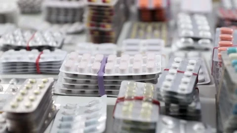 Pan shot over stacks of blisters full of pills on a desk Stock Footage 280677488