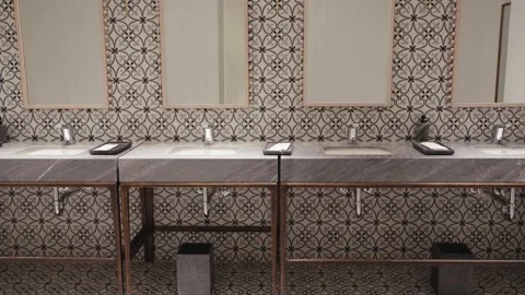 Pan Shot from Patterned Floor to Marble Restroom Vanity Stock Footage 333934850