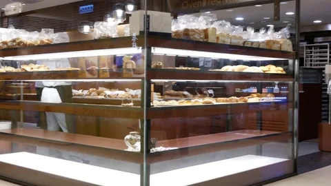Pan shot of people buying bread and Mos burger inside shopping mall Stock Footage 84454873