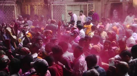 Pan shot of people celebrating Holi festival at Banke Bihari Temple Stock Footage