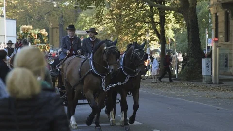 Pan shot, of people on a wagon pulled by brown horses, at a parade, at Stock-Footage 97650018