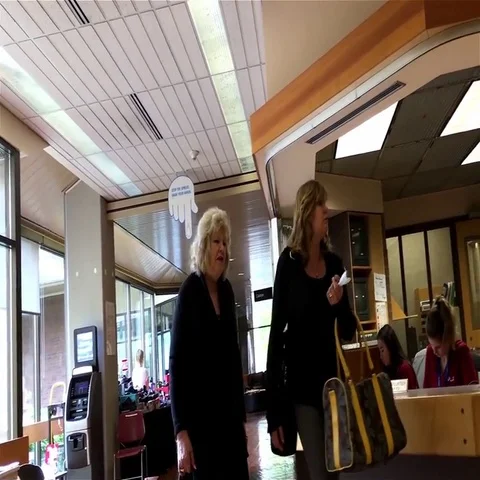 Pan shot of people walking throught information area inside Eagle Ridge hospital Stock Footage 69560412