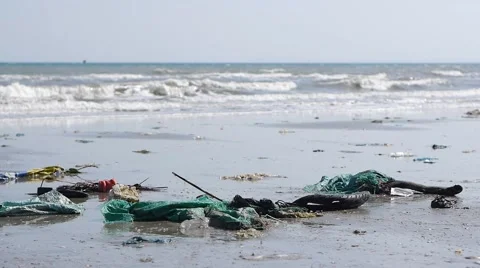 Pan shot of plastic garbage and trash on the beach. Close up Stock Footage 50786554