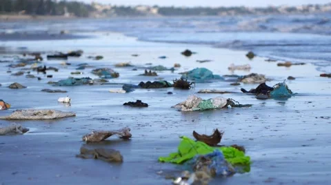 Pan shot of plastic garbage and trash on sand on seashore Stock-Footage 50789737