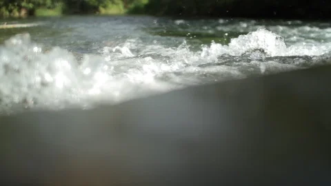 Pan shot with reflections of a small creek Stock Footage 86742425