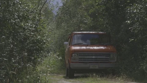 Pan shot to the right of a car standing in the nature. Stock Footage 69859802