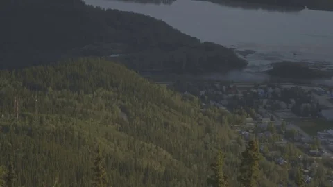 Pan shot to the right of a small town at a river. Stock Footage 69209298