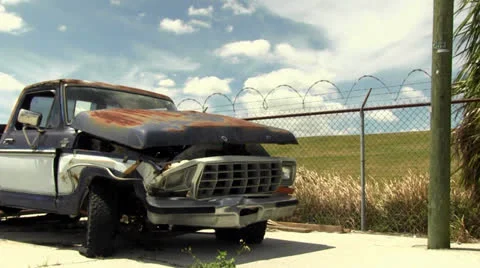 Pan shot of a rusty and smashed pickup truck Stock Footage 22802650