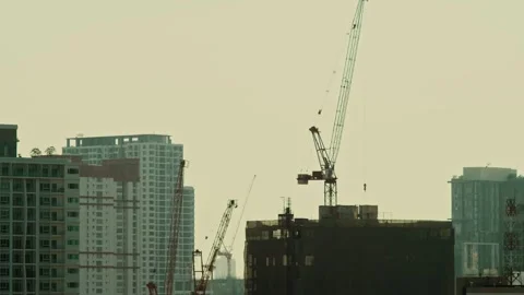 Pan shot of skyscraper building under construction in the big city with 2 cranes Stock Footage 280971165