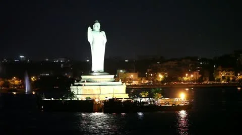 Pan shot of a statue of Lord Buddha lit up at night Stock Footage 30035751