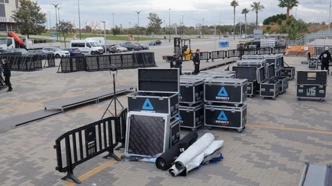 Pan shot of the technical preparation of the stage of an outdoor event Video stock 123405267