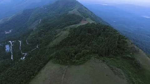 Pan shot of thick forest and green hill from Copter 動画素材 90896223
