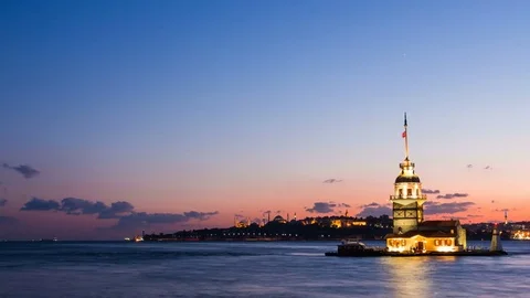 Pan shot timelapse of Maiden Tower or Kiz Kulesi with floating tourist boats on Stock Footage 80288581
