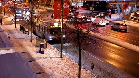 Pan shot of traffic flow on cold blizzard snow winter night Video stock 70499743
