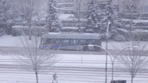 Pan shot of traffic flow on cold blizzard snow winter day Stock Footage 70860343