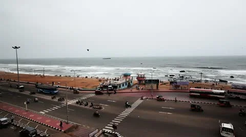 Pan shot of traffic moving on the Beach Road at Ramakrishna Beach Stock Footage 30042987