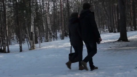 Pan shot of two young lovers  walk in the forest glade Stock Footage 76555518
