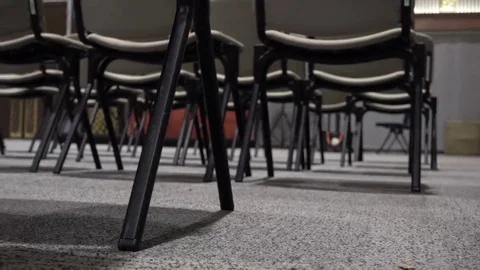 Pan shot of under chairs in a lecture Stock Footage 69245597