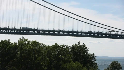 Pan shot of the Verrazano Bridge through the trees. Bay Ridge Brooklyn. Stock Footage 220732253
