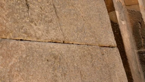 Pan shot to a very ancient monumental rocks and wall and an arabian horse Stock Footage