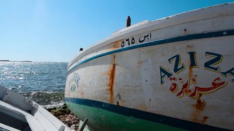 Pan shot view of the sea behind two fishing boats Video stock 80295388