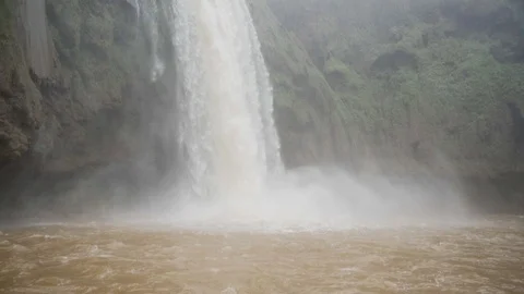 Pan up shot from water level of a big waterfall in North Africa Stock Footage 100269922
