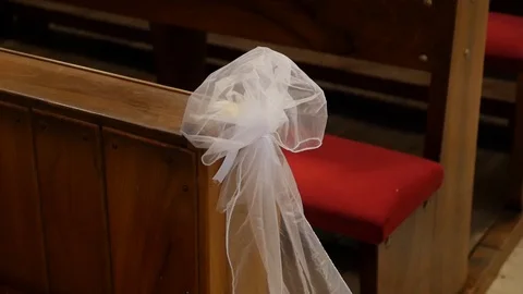 Pan shot of white bow on bench in the church Stock Footage 87978514