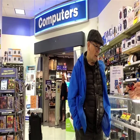 Pan shot of worker explaining camera function for customer Stock Footage 69700767