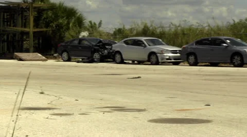 Pan shot of wrecked late-model cars Stock Footage 22843296