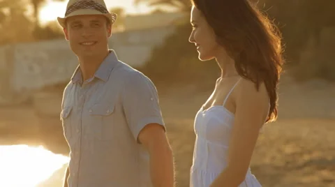 Pan shot of young couple walking on beach Stock Footage 43620153