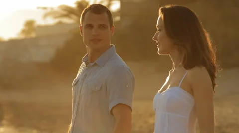 Pan shot of young couple walking on beach Stock Footage 43620165