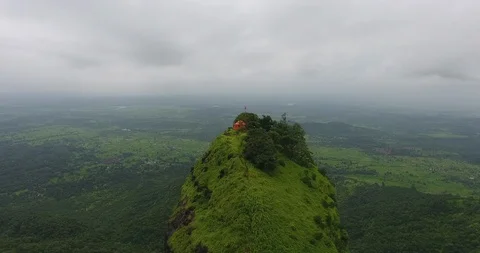 Pan shots of a structure on top of a mountain in a lush green forest. Stock Footage 117008143