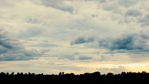 Pan of sky and tree line on a cloudy day in the country Stock Footage 158924937