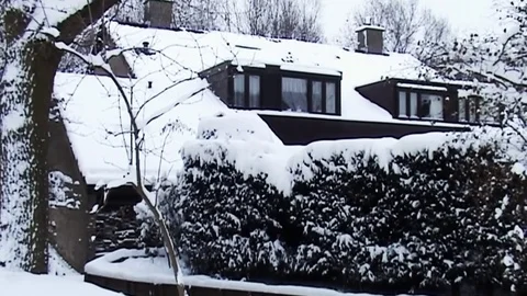 Pan in the snow from house to the road Stock Footage 83829207