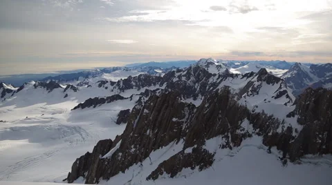 Pan of snowy mountain range at dawn Video stock 55539333