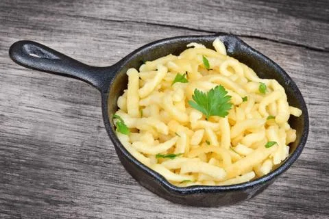 Pan with spatzle on old table Stock Photos