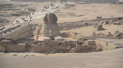 Pan up from the Sphinx to Pyramids -  Giza Egypt Stock Footage 59910060