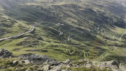 Pan of Splugen Pass at sunset with cool lens flare - Italy Switzerland Alps Vidéo 319234565