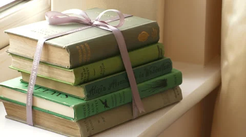 Pan to stack of antique classic Books Stock Footage 35754162