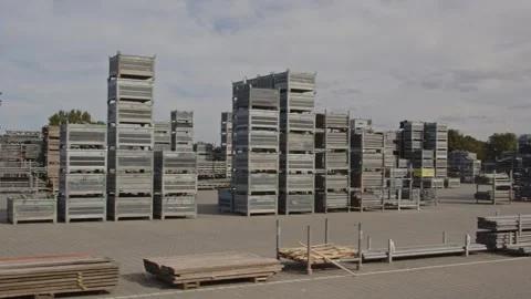 Pan of stacked construction materials on an industrial storage yard on a sunny Stock Footage 318348803
