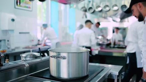 Pan on the stove in the kitchen of the restaurant Stock Footage 77709986