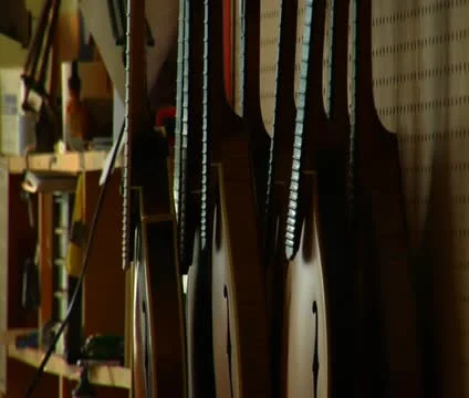 Pan from stringed instruments to worker Video stock 21592970