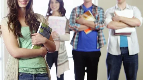 Pan up of students holding textbooks Stock Footage 80227279