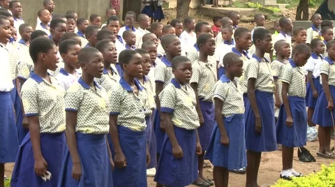 PAN ON STUDENTS SINGING AT MORNING ASSEMBLY Stock Footage 60116017