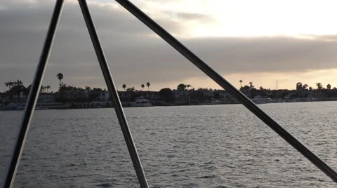 Pan of sun streaking through clouds yachts harbor view from 3 bimini supports Stock Footage 67467474