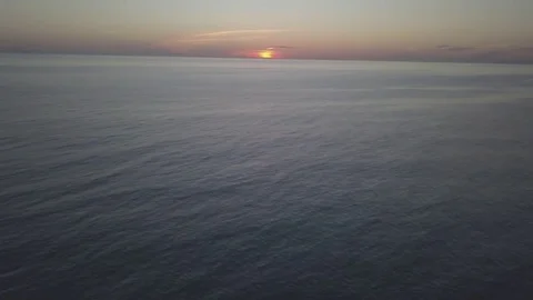 Pan up to sunset in open ocean Stock Footage 82761842