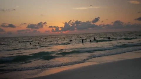 Pan up Sunset at Pass-a-grille Beach in St Petersburg Florida. Low light with mu Stock Footage 276676279