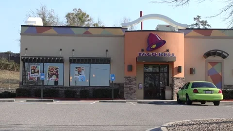 Pan of Taco Bell and distant traffic Stock Footage 149222596