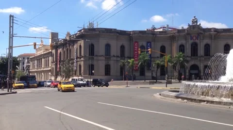 Pan from taxi passing by the fountain downtown Cordoba, Argentina Stock Footage