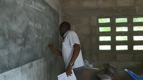 PAN FROM TEACHER AT BLACKBOARD TO STUDENTS IN CLASS Stock Footage 60116110